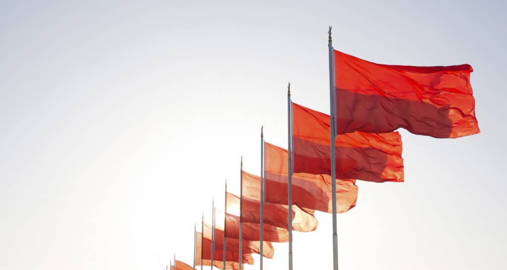 Row of red flags on flag poles